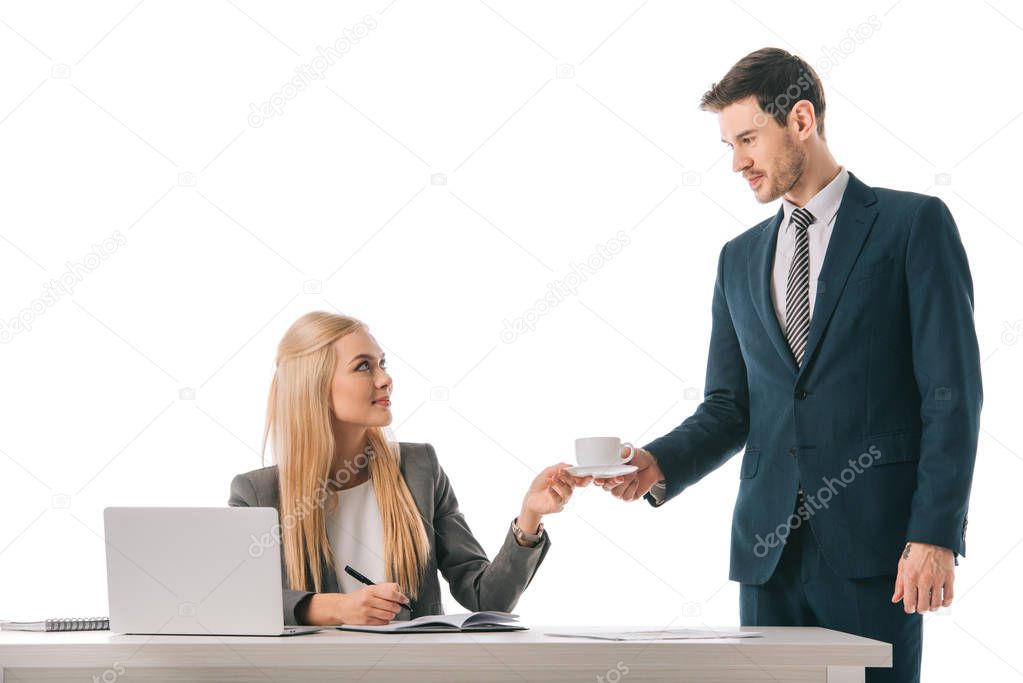 male secretary brought cup of coffee for professional businesswoman at workplace with laptop, isolated on white