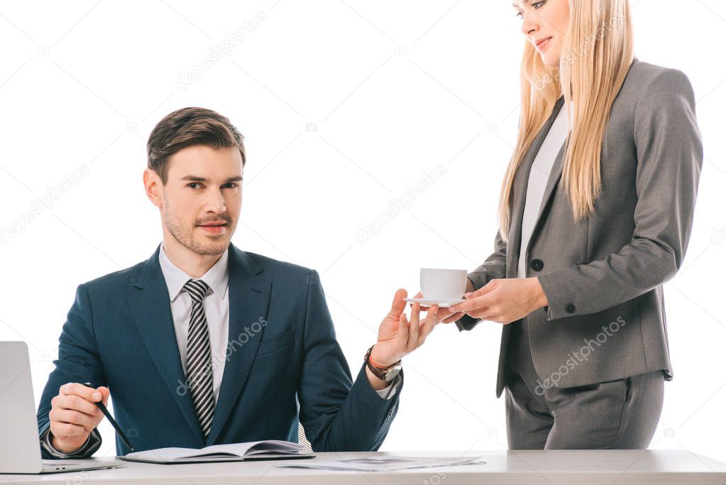female secretary brought cup of coffee for businessman at workplace isolated on white