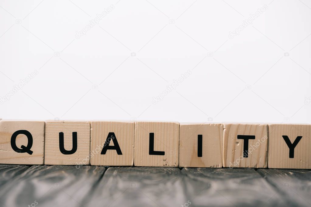 equality word made from alphabet cubes on wooden table on white