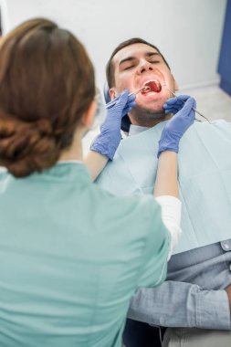 açık ağız ile muayene hasta seçici odak bir dişçi lateks eldiven