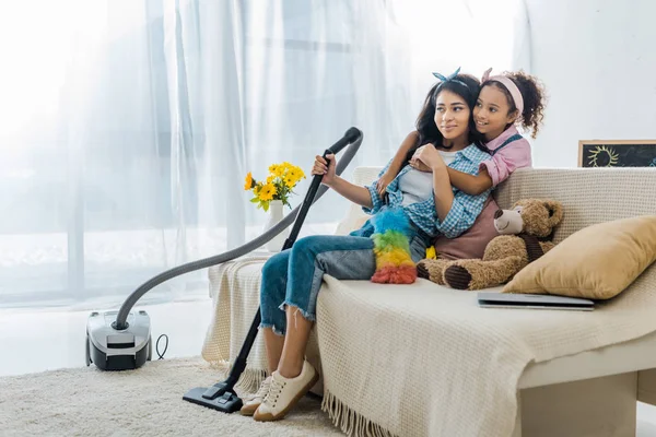 Cute African American Mother Hugging Tired Mother Sitting Sofa — Stock Photo, Image