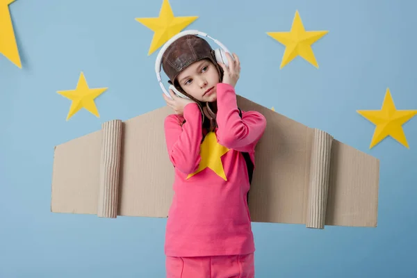 Dreamy Child Cardboard Wings Listening Music Blue Starry Background — Stock Photo, Image
