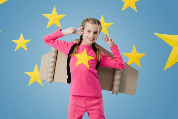Laughing Kid Cardboard Wings Showing Peace Sign Blue Starry Background — Stock Photo, Image