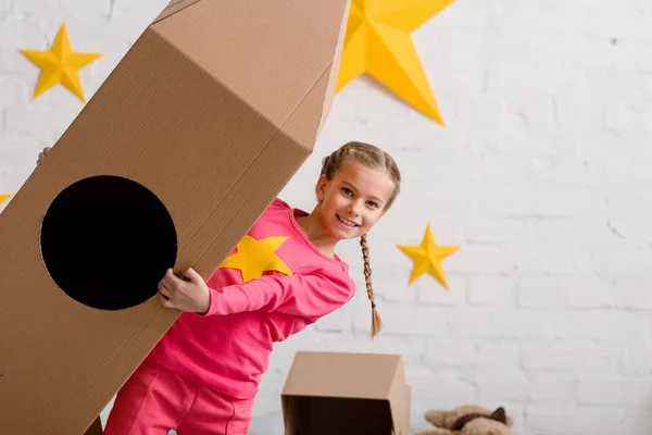 Laughing Kid Pink Clothes Holding Big Cardboard Rocket — Stock Photo, Image