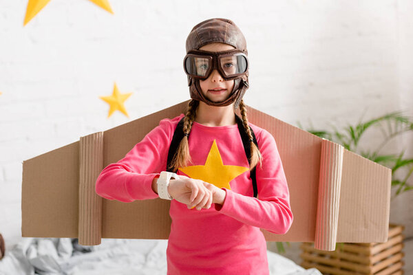 Cute child in helmet and goggles looking at camera