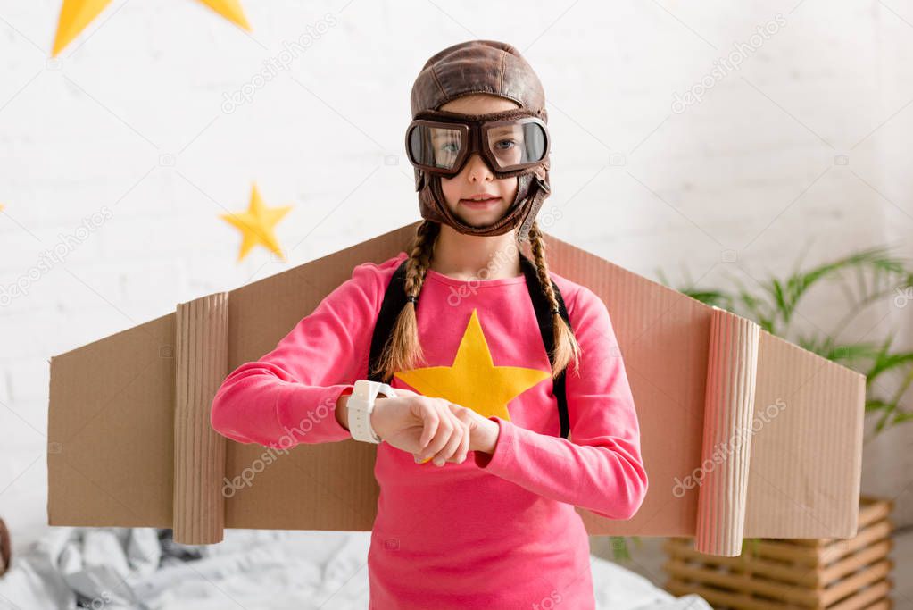Cute child in helmet and goggles looking at camera