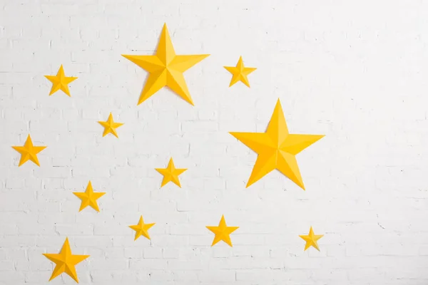 Yellow cardboard stars on light textured background
