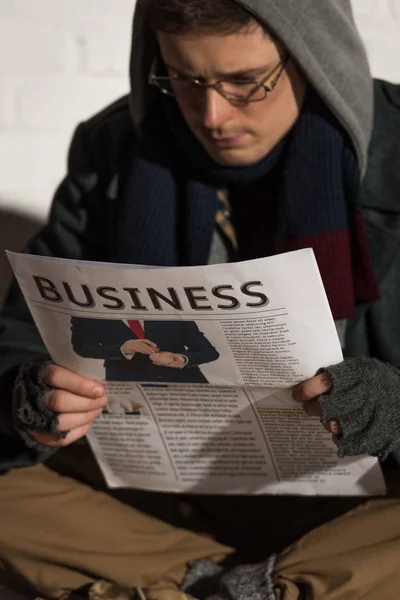Selective Focus Homeless Man Glasses Hood Reading Business Newspaper — Stock Photo, Image