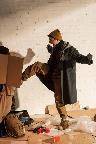 Aggressive Screaming Homeless Man Kicking Trash Container Cardboard Box — Stock Photo, Image