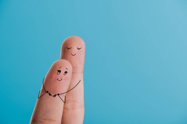 partial view of happy couple of fingers hugging isolated on blue clipart