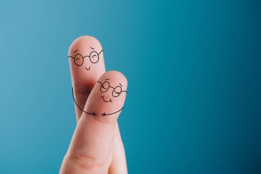 cropped view of happy couple of fingers in eyeglasses hugging isolated on blue clipart