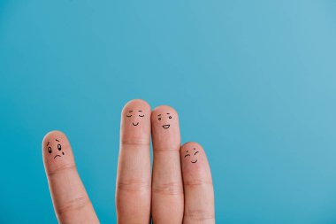 cropped view of happy fingers with one sad isolated on blue clipart