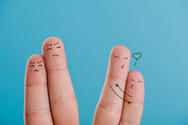 cropped view of happy and dissatisfied couples of fingers isolated on blue