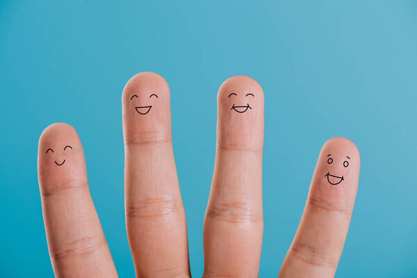 cropped view of smiling human fingers isolated on blue