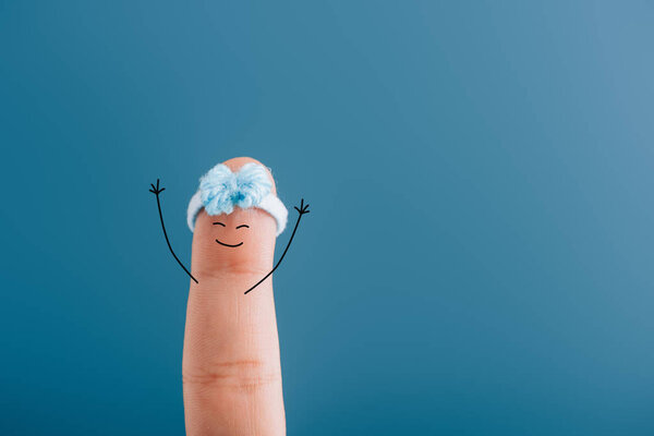cropped view of finger as cheerful woman isolated on blue
