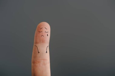 cropped view of one lonely finger crying isolated on grey clipart
