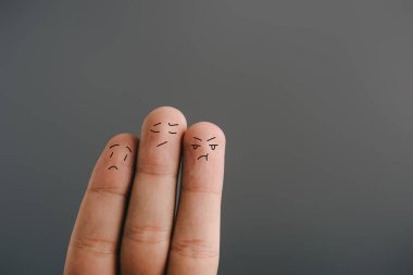 cropped view of worried human fingers isolated on grey clipart
