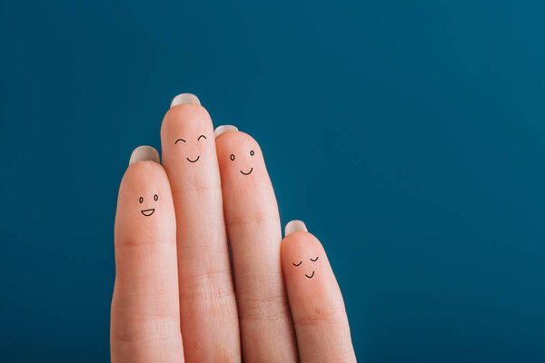 cropped view of happy human fingers isolated on blue