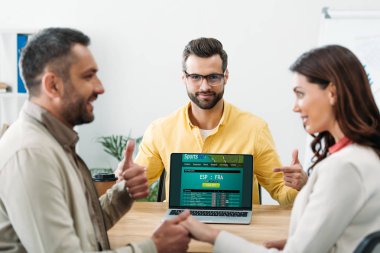seçici odak iki office içinde laptop ekranında sportsbet online web sitesi ile parmak ile işaret Danışmanı