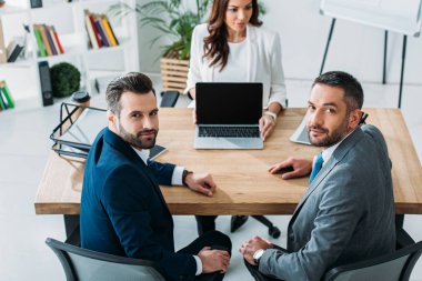 seçici odak fotoğraf makinesi ve güzel Danışmanı ile kopya alanı işyeri dizüstü bilgisayarı gösteren bakarak yatırımcıların 