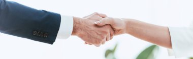 selective focus of woman and man shaking hands at office 