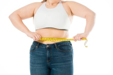 cropped view of overweight woman measuring waist isolated on white clipart