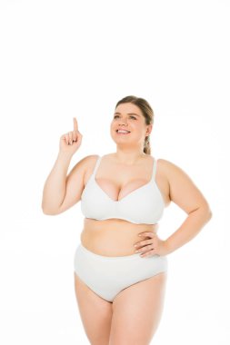 smiling overweight girl in underwear showing idea sign isolated on white, body positivity concept  clipart