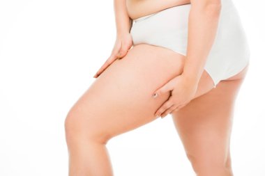 cropped view of overweight woman posing with hands on leg isolated on white, body positivity concept clipart