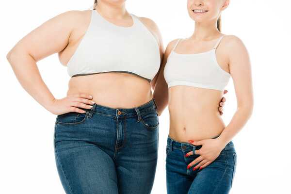 cropped view of happy slim and overweight women hugging isolated on white, body positivity concept
