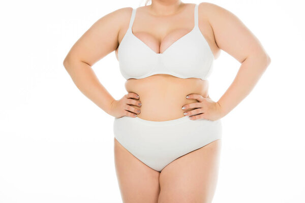 cropped view of overweight woman in underwear with hands on hips isolated on white, body positivity concept 