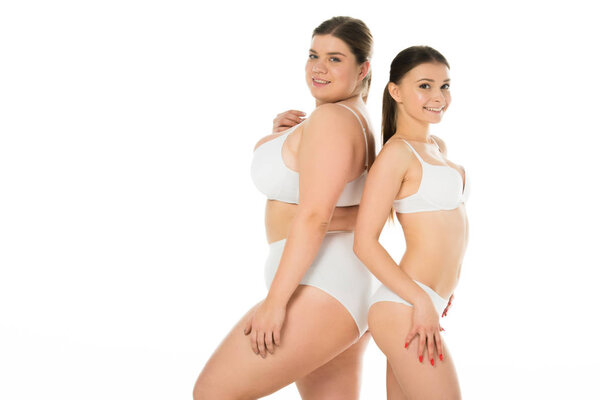 young slim and overweight women in underwear posing together isolated on white