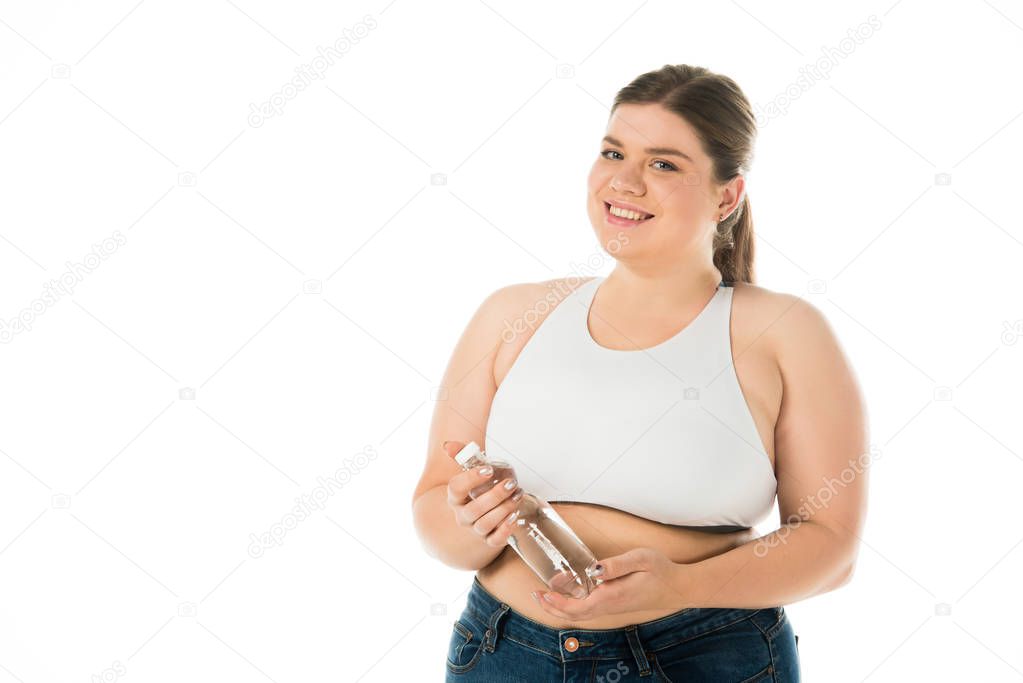 smiling overweight woman holding bottle with water isolated on white