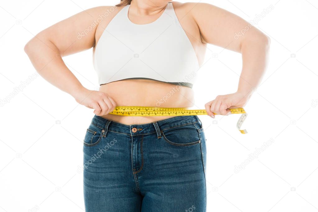 cropped view of overweight woman measuring waist isolated on white