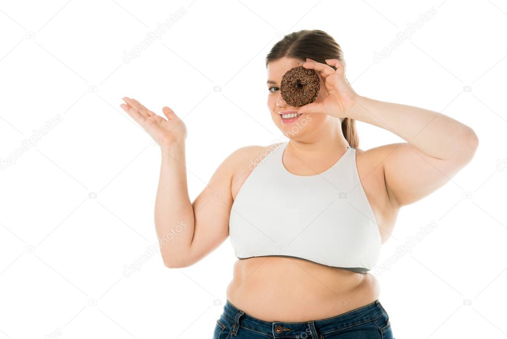 smiling overweight woman holding sweet doughnut isolated on white, body positivity concept