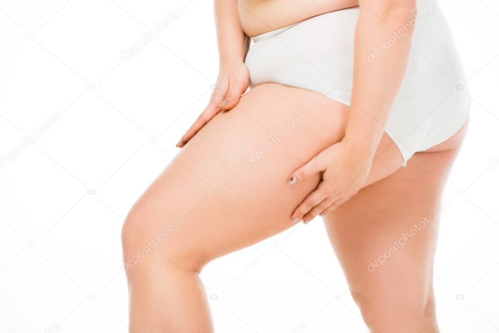 cropped view of overweight woman posing with hands on leg isolated on white, body positivity concept