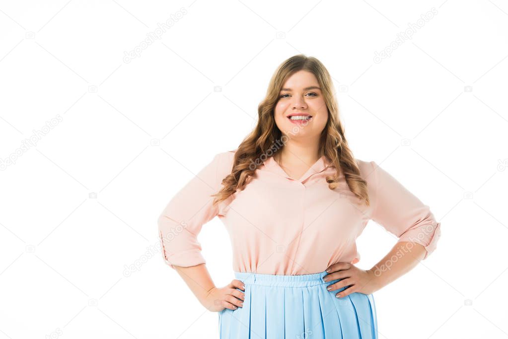 smiling happy plus size woman posing with hands on hips isolated on white