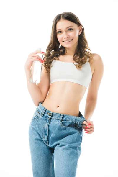 Smiling Slim Girl Holding Big Jeans Holding Bottle Water Isolated — Stock Photo, Image