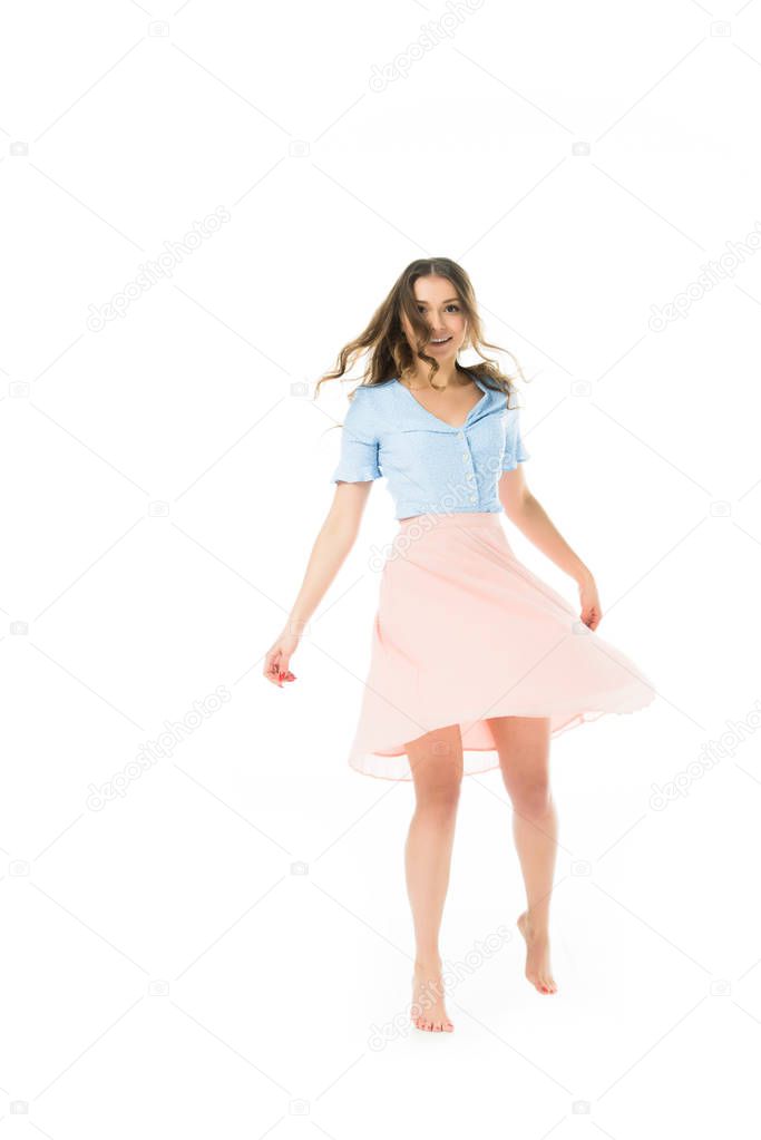 smiling pretty elegant woman whirling isolated on white
