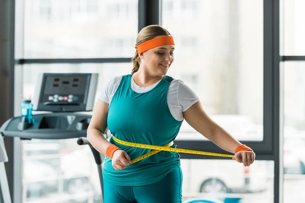 Cheerful Size Girl Looking Measuring Tape While Measuring Waist Gym — Stock Photo, Image