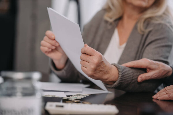 senior couple sitting at table and reading document at home
