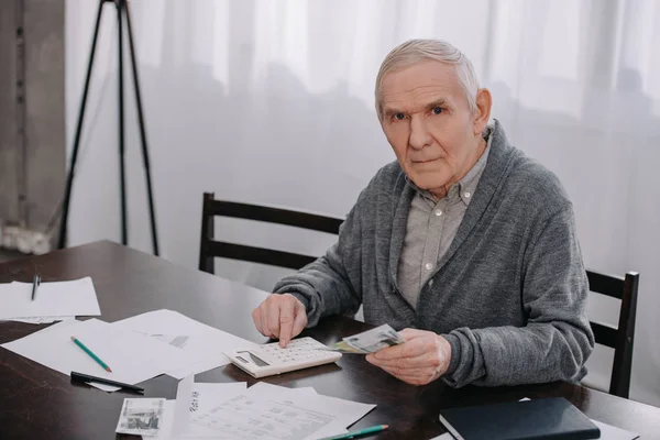 Starszy Człowiek Ubranie Siedzi Przy Stole Papierkową Robotę Pomocą Kalkulatora — Zdjęcie stockowe