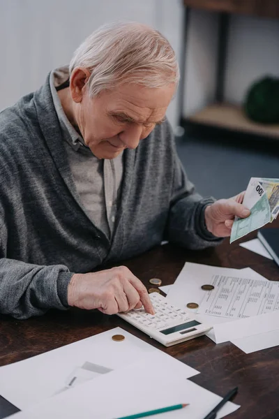 Senior Man Sitting Table Paperwork Using Calculator While Counting Money — Stock Photo, Image