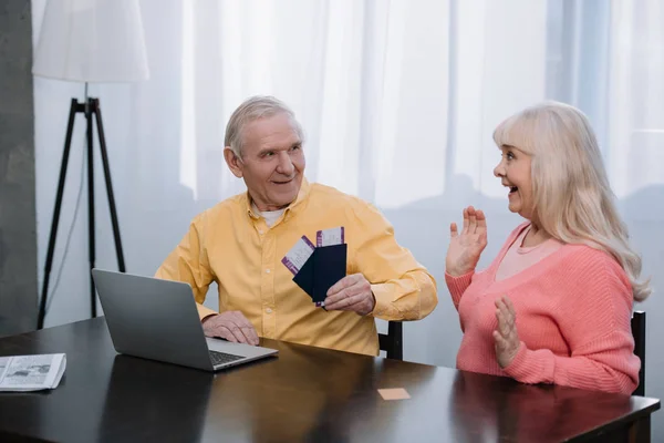 Senior Man Holding Air Tickets Passports Surprised Woman Gesturing Hands — Stock Photo, Image