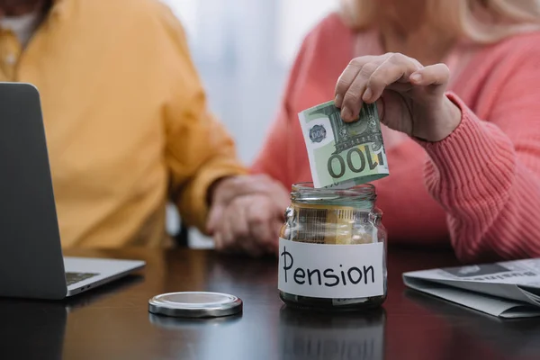 Cropped View Senior Couple Putting Money Glass Jar Pension Word — Stock Photo, Image