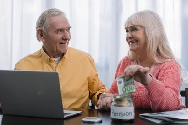 Pasangan Senior Duduk Meja Dengan Laptop Sementara Wanita Menaruh Uang — Stok Foto