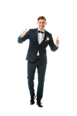 smiling bridegroom in black suit showing thumbs up isolated on white clipart