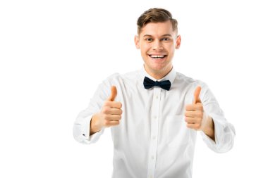 happy handsome groom showing thumbs up and looking at camera isolated on white clipart