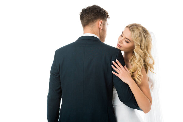 back view of bridegroom hugging beautiful bride isolated on white