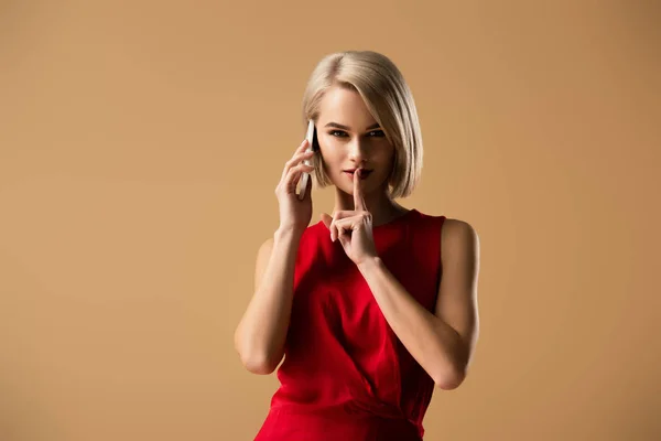 Elegant Blonde Woman Talking Smartphone Touching Lips Finger Isolated Beige — Stock Photo, Image