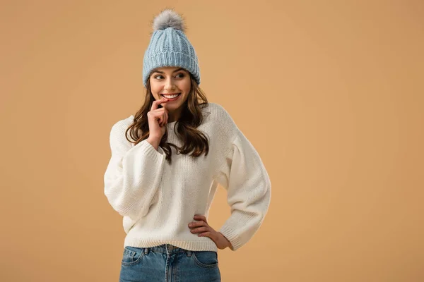 Cheerful Brunette Woman Knitted Hat Touching Lip Finger Looking Away — Stock Photo, Image